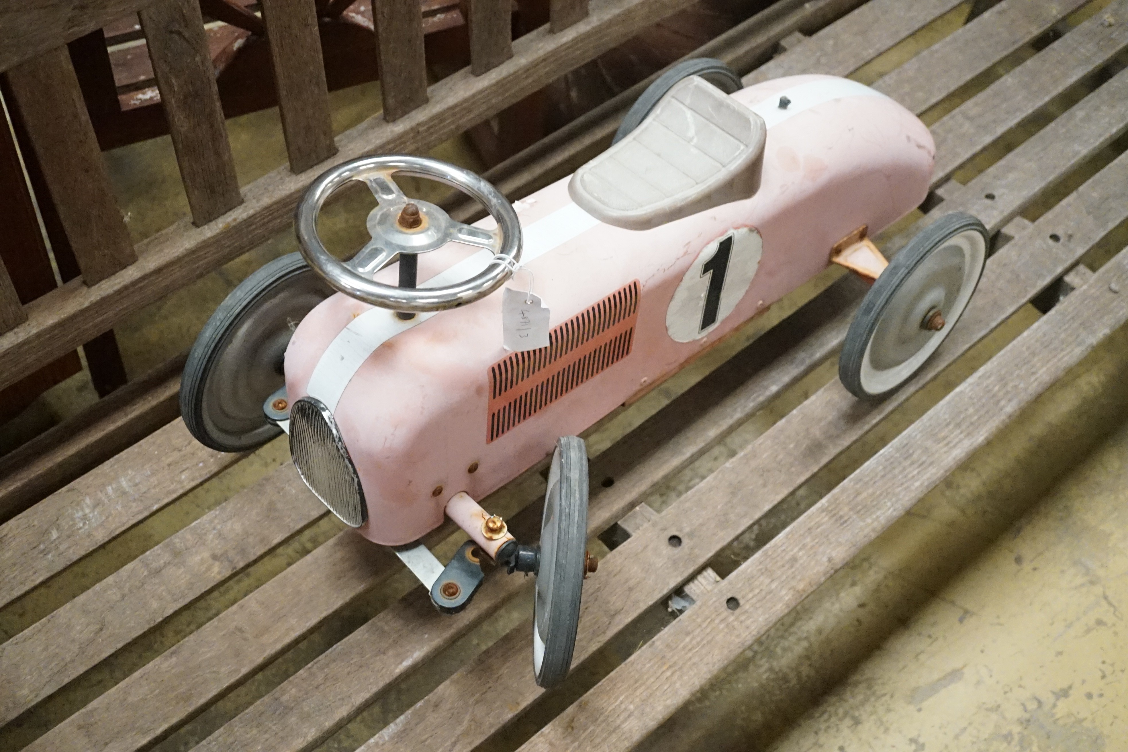 A child's sit-on toy racing car
